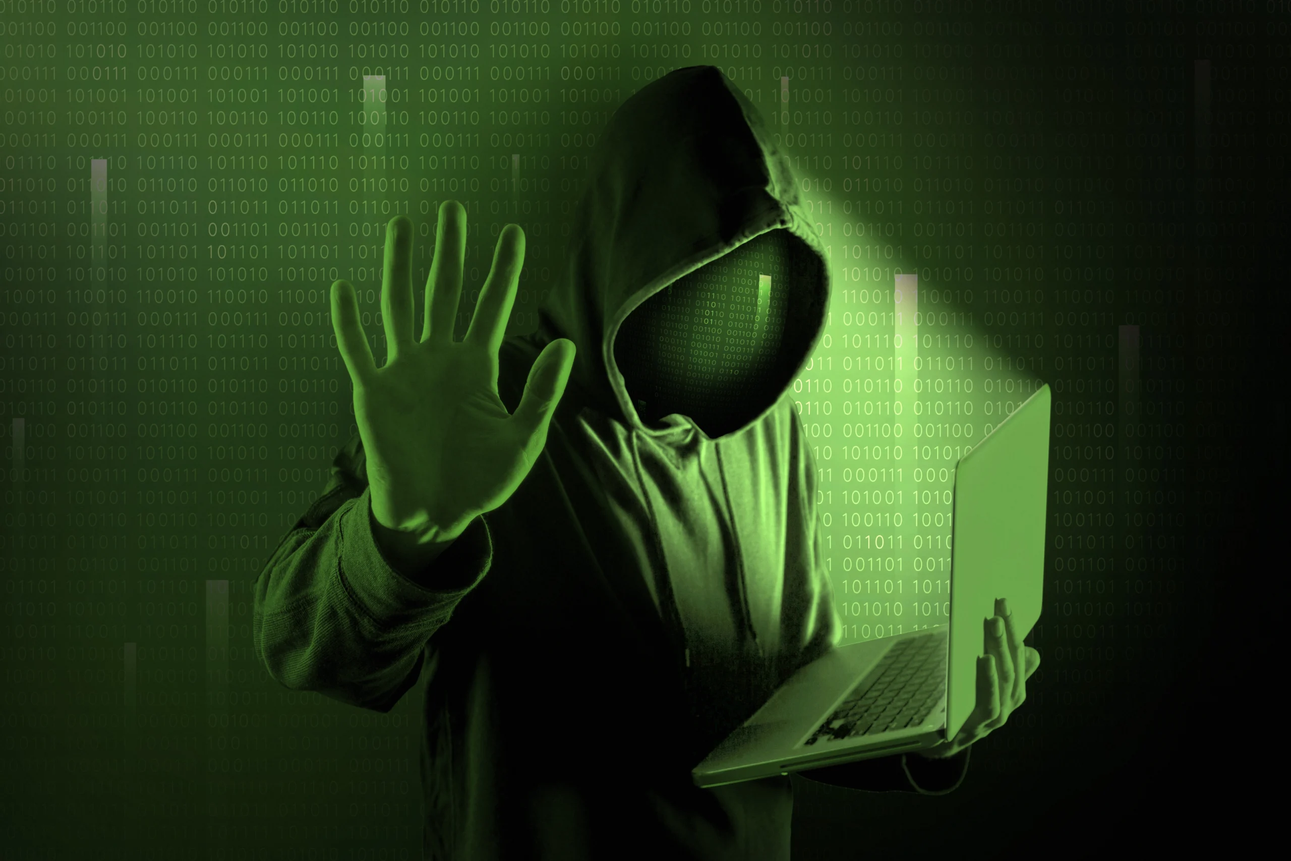Hacker in a green light using deep dark web.